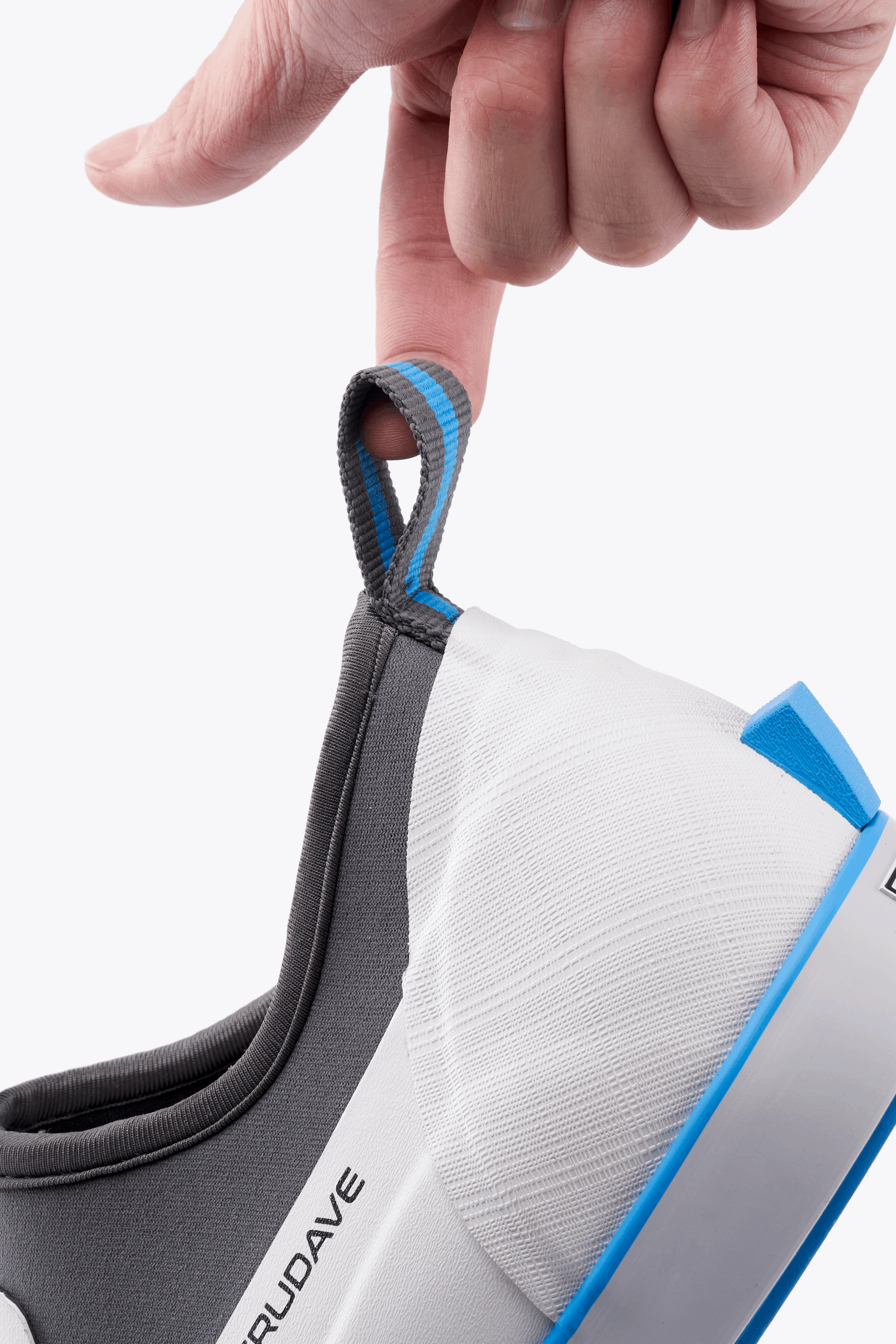 Hand lifting Trudave NeopreneTrek Series white waterproof slip-on fishing deck boot by its rear pull tab, showing easy on-and-off design and durable neoprene construction for fishing and boating use.